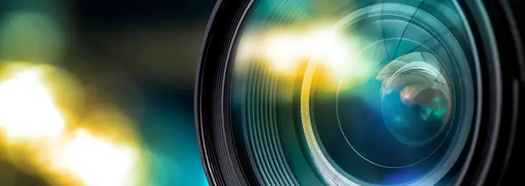 In front of a camera lense with yellow and green effects