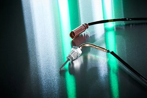 Exhaust Gas Temperatur Sensor on a table with green lighting