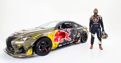 Ahmad Daham standing right to his Lexus holding his helmet on a plain white background