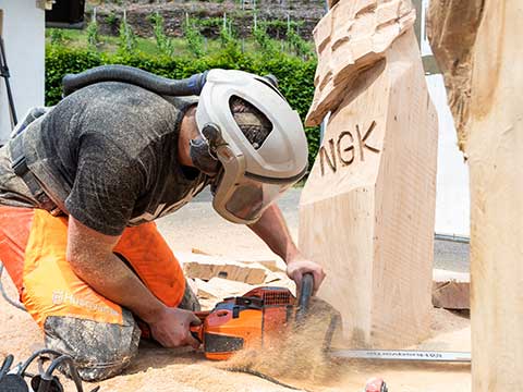 Chainsaw artist carving wood with a chainsaw