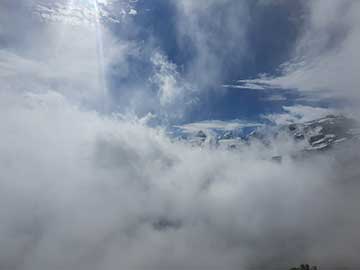 Cloudy view over the Stelvio Pass, a bit of mountains viewable